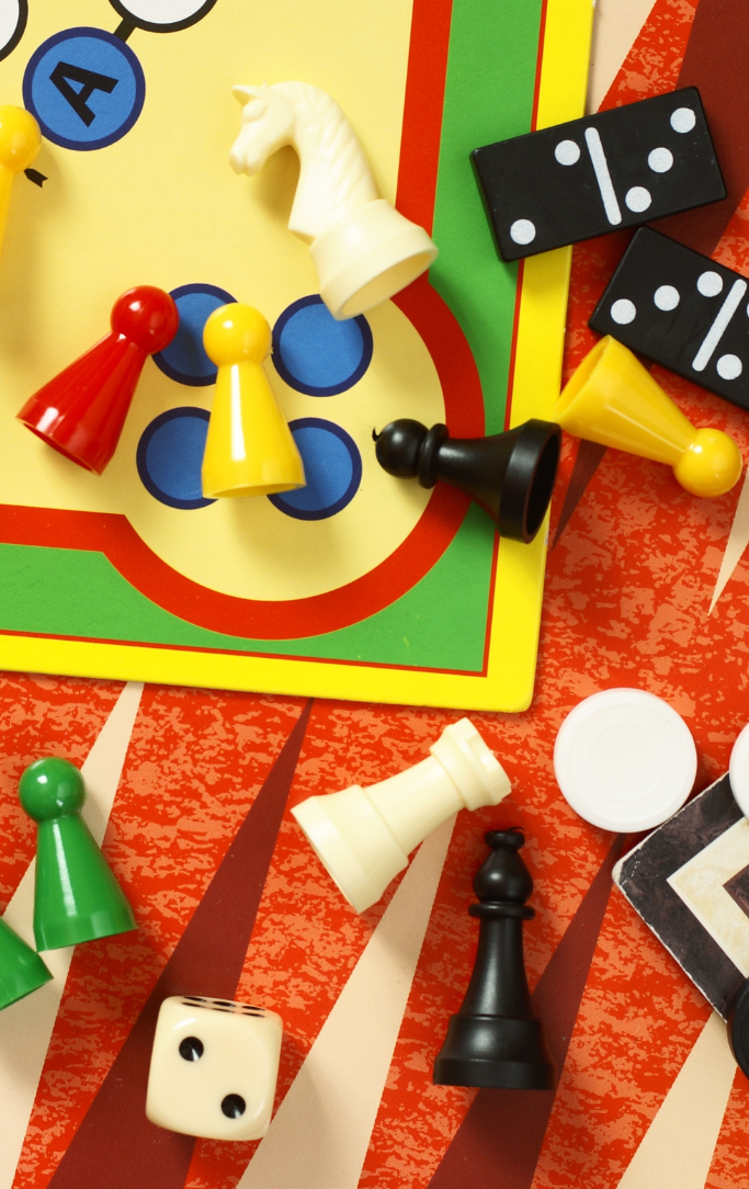 variety of board game pieces on a generic game board