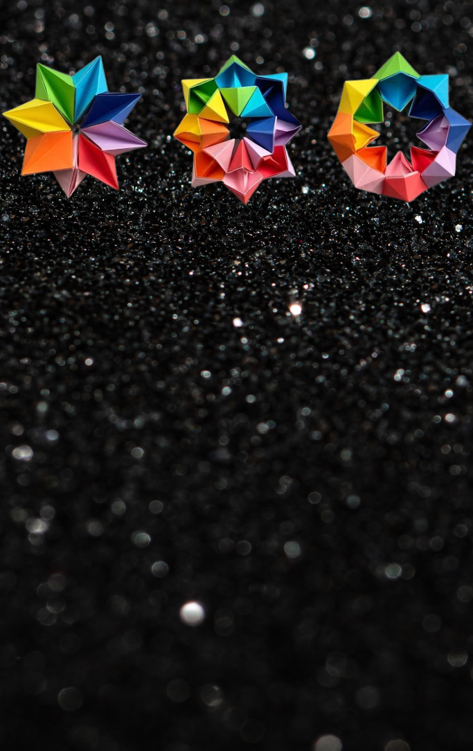 rainbow origami magic circle on black sparkly background