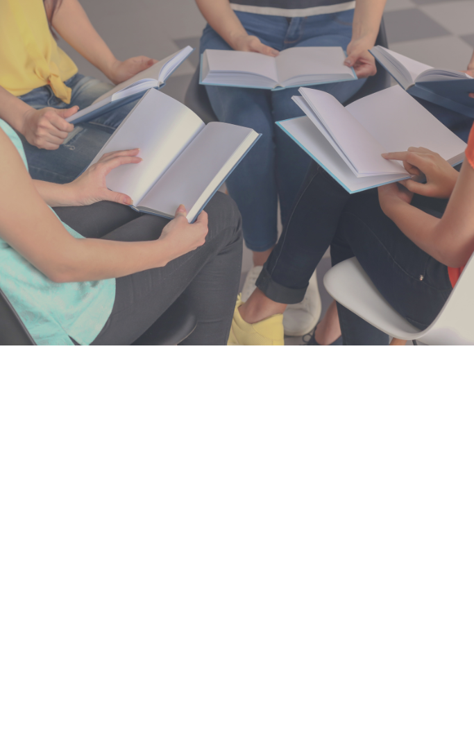 people sitting in a circle and reading a book
