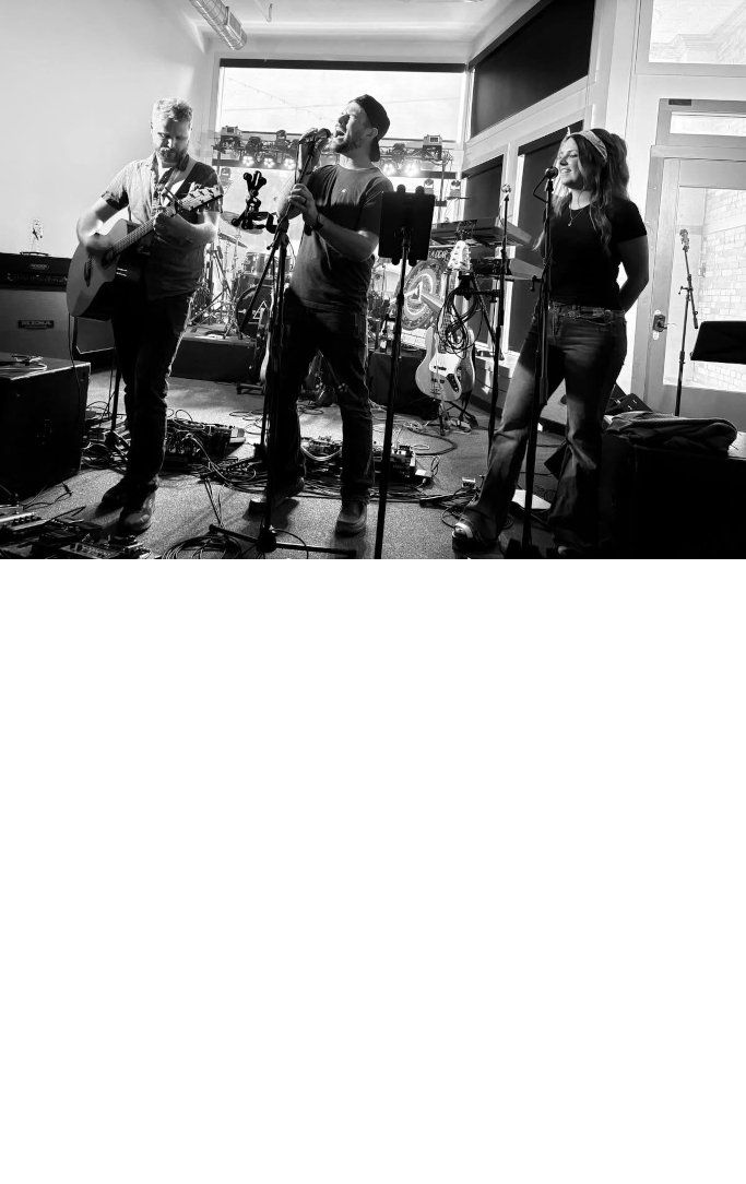 three musicians performing in a small venue