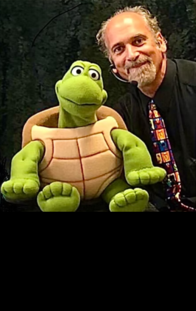 man holding a turtle puppet